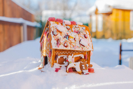 Gingerbread house stands in the snowの写真素材