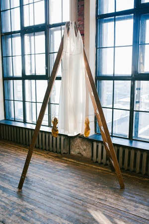 Dress hanging on a ladder in the Studioの写真素材
