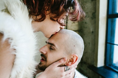 Woman kisses the head bald menの写真素材