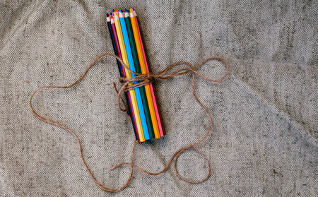 Colored pencils tied with threadの写真素材
