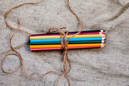 Colored pencils tied with threadの写真素材