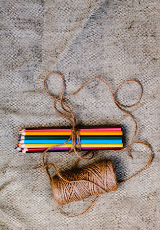 Colored pencils tied with threadの写真素材