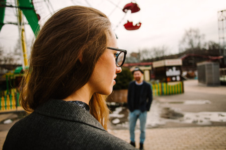 woman in glasses near the Ferris wheelの写真素材