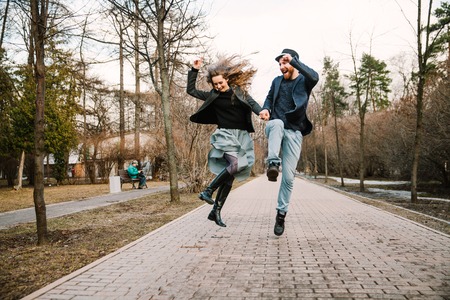 Man and woman holding hands and runの写真素材