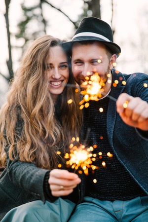 A man and woman held sparkler. Love time