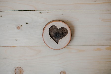 Heart of wood on wooden background. Heartの写真素材