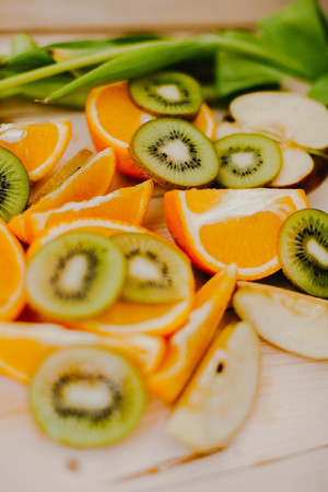 Orange slices and Kiwi fruit on wood backgroundの写真素材