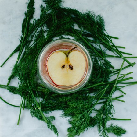 Half the apples in a glassの写真素材