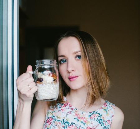 Girl eating muesli out of Cup. Foodの写真素材