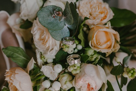 Wedding rings on the background of the bouquetの写真素材