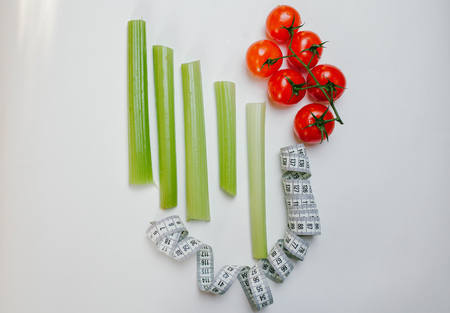 celery, tomatoes and tape on a white background. Veganの写真素材