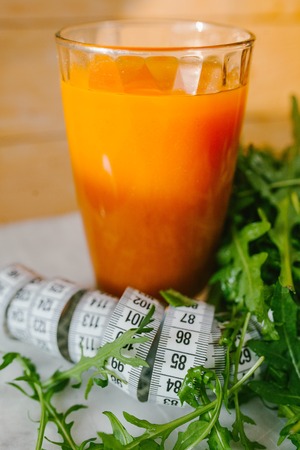 carrot juice in a glass with tape and lettuce. natureの写真素材