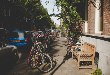 Green Street with parked bicycles. Cityの写真素材
