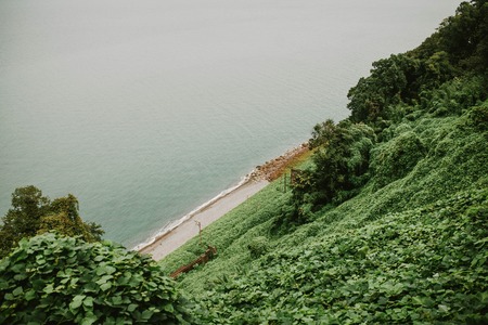 A view of the sea and the green hills, natureの写真素材