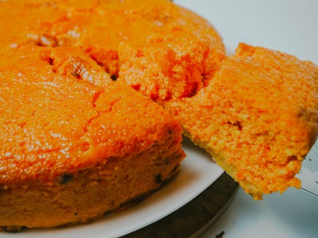 carrot cake with a cut piece on a plate, food