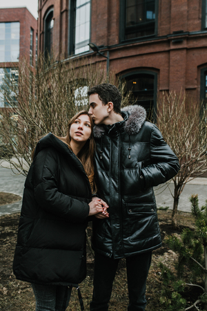 a couple in love stands on the street and warm each otherの写真素材