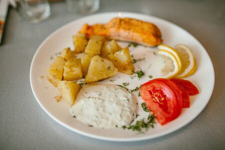 Potatoes with salmon with cream sauce. Supper.の写真素材