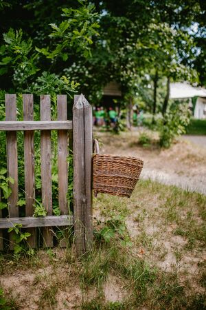woven basket on a wooden fence, woodの写真素材