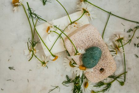 View from above on white soap, pumice and daisies on a light background, spaの写真素材
