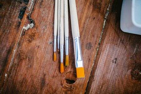 Brushes for drawing on a wooden background, artの写真素材