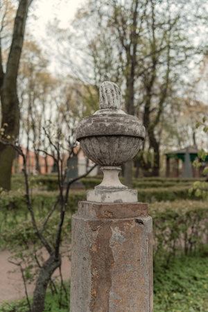Old stone lantern in the park on a blurred background of trees.の写真素材
