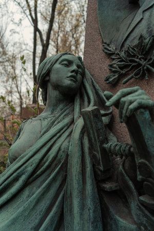 A closeup of a green statue in a cemeteryの写真素材