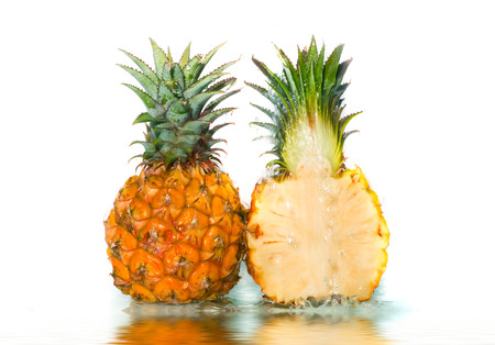 Pineapple with poured water. Isolation on whiteの写真素材