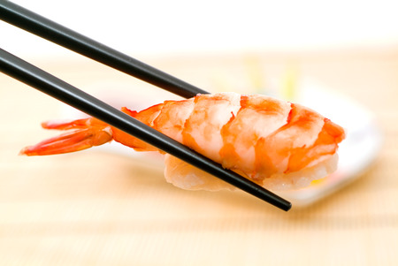 Sushi with chopsticks, With a back backgroundの写真素材