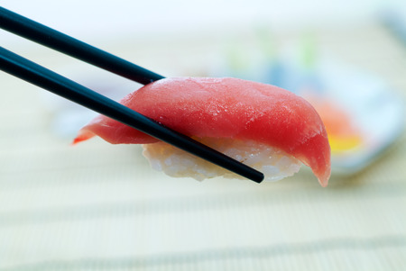 Sushi with chopsticks, With a back backgroundの写真素材