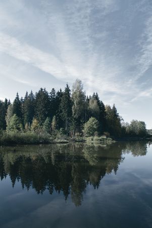 sky reflecting in a calm northern lakeの写真素材