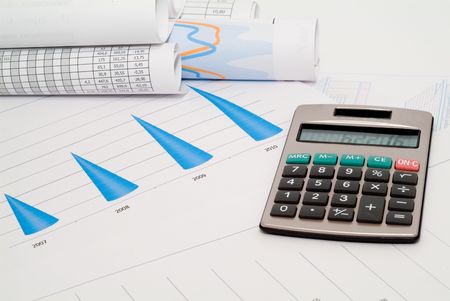 Business accessories on a background of diagrams.の写真素材