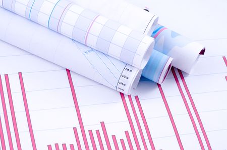 Business accessories on a background of diagrams.の写真素材