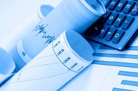 Business accessories on a background of diagrams.