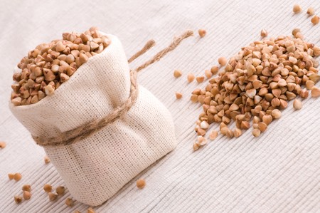 raw buckwheat in small sackの写真素材