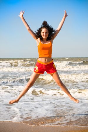 happy young woman is jumping in beach
の写真素材