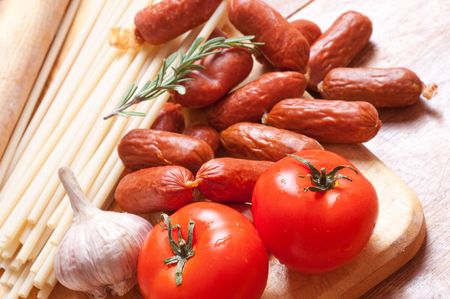 Smoked sausages on a wooden boardの写真素材