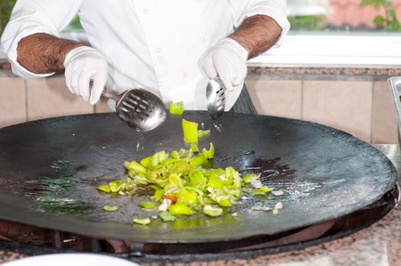 cook fries vegetables on a frying panの写真素材