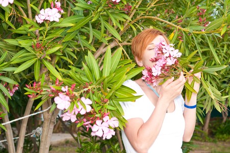 woman with branch of blooming tree at spring park