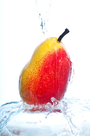 pear  into water splash on whiteの写真素材
