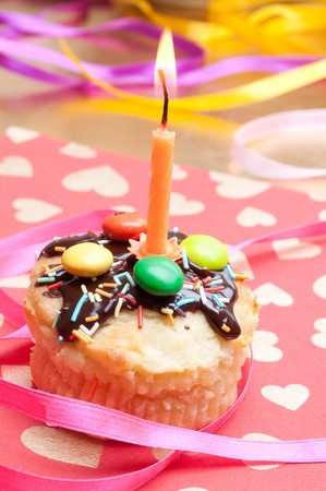 cupcake with sprinkles and candleの写真素材
