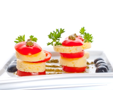 cheese and a tomato with sauce.の写真素材