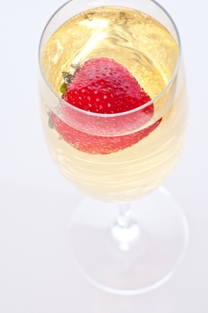 fresh strawberry floating in glass of champagneの写真素材