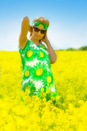 beautiful woman on rape fieldの写真素材