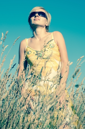 young woman on the fieldの写真素材
