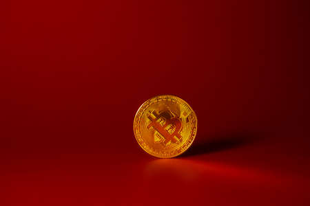 Bitcoin on a red background. Blockchain, token, cryptocurrency. Exchange of currencies. Money. gold coinの写真素材