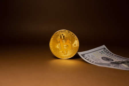 Bitcoin on a red background. Blockchain, token, cryptocurrency. Exchange of currencies. Money. gold coinの写真素材
