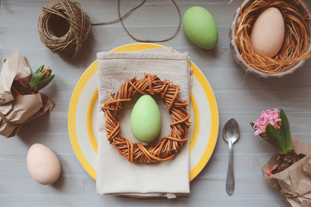Easter and spring preparations. Hyacinth, eggs and garden tools on table, top view. Selective focus, cozy home interior.の写真素材