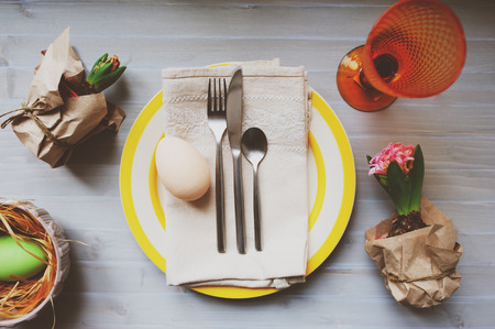 Easter and spring preparations. Hyacinth, eggs and garden tools on table, top view. Selective focus, cozy home interior.の写真素材