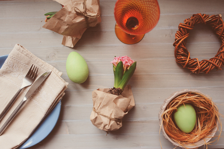 Easter and spring preparations. Hyacinth, eggs and garden tools on table, top view. Selective focus, cozy home interior.の写真素材