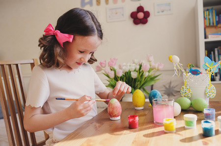 easter craft with kids - painting eggs at home. Seasonal spring decorationsの写真素材